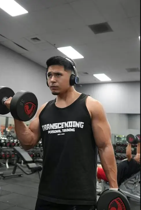 Mark Villanueva Jr., founder of Transcending Personal Training, training with a dumbbell