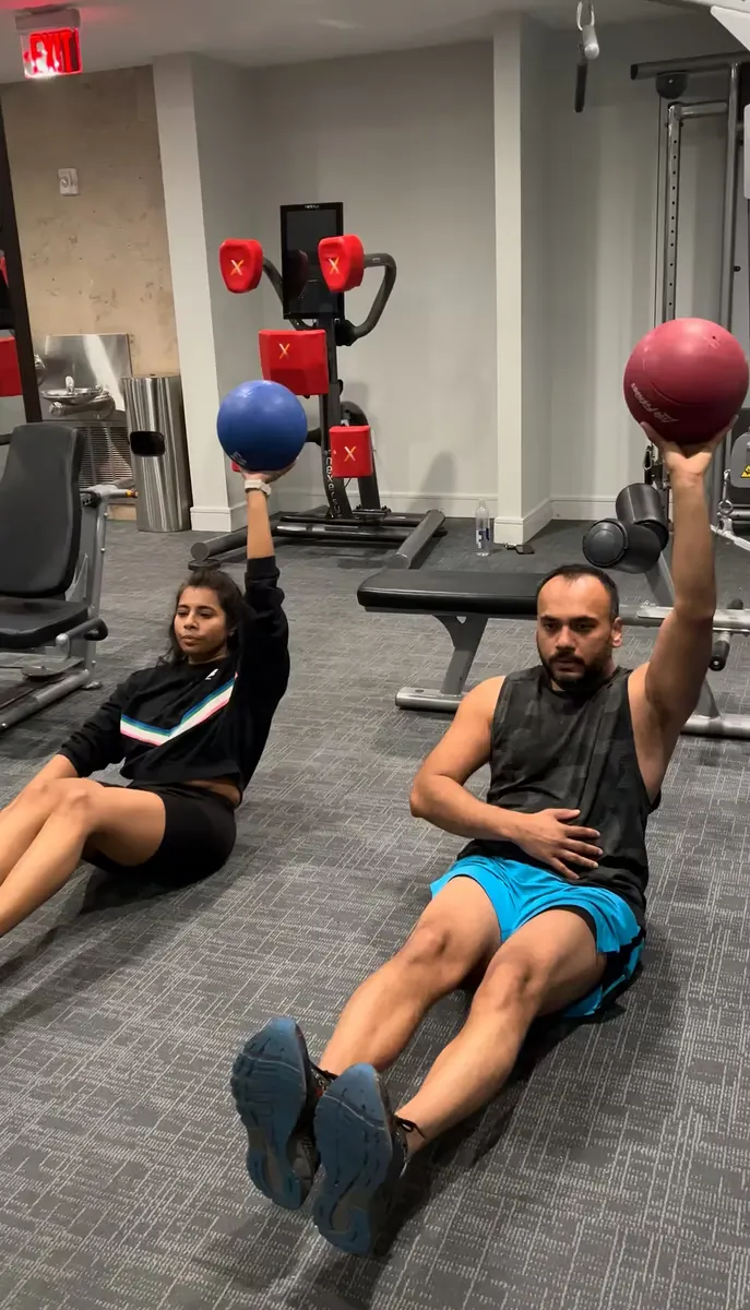 A couples workout in an apartment gym in Austin